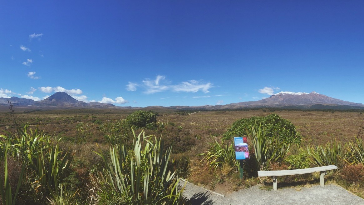 View of Mount Ngauruhoe on the left and snow-covered Mount Ruapehu on the right from a viewing platform on the Mounds walk in the Ruapehu region, North Island, New Zealand.