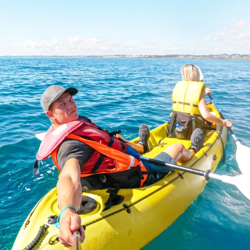 Sabina and Liam sea kayaking off the coast of New Plymouth toward Sugar Loaf Island, North Island, New Zealandy