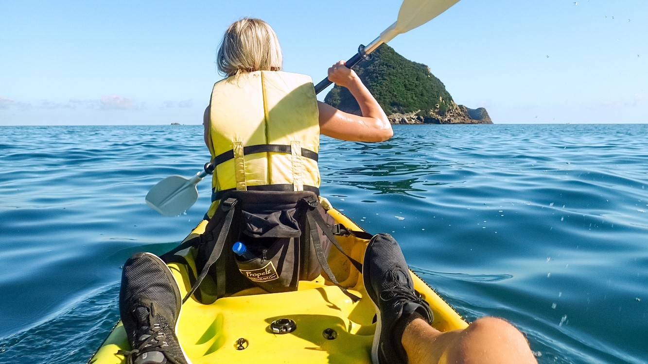 Sabina and Liam on a kayak getting closer to Sugar Loaf Island, North Island, New Zealand