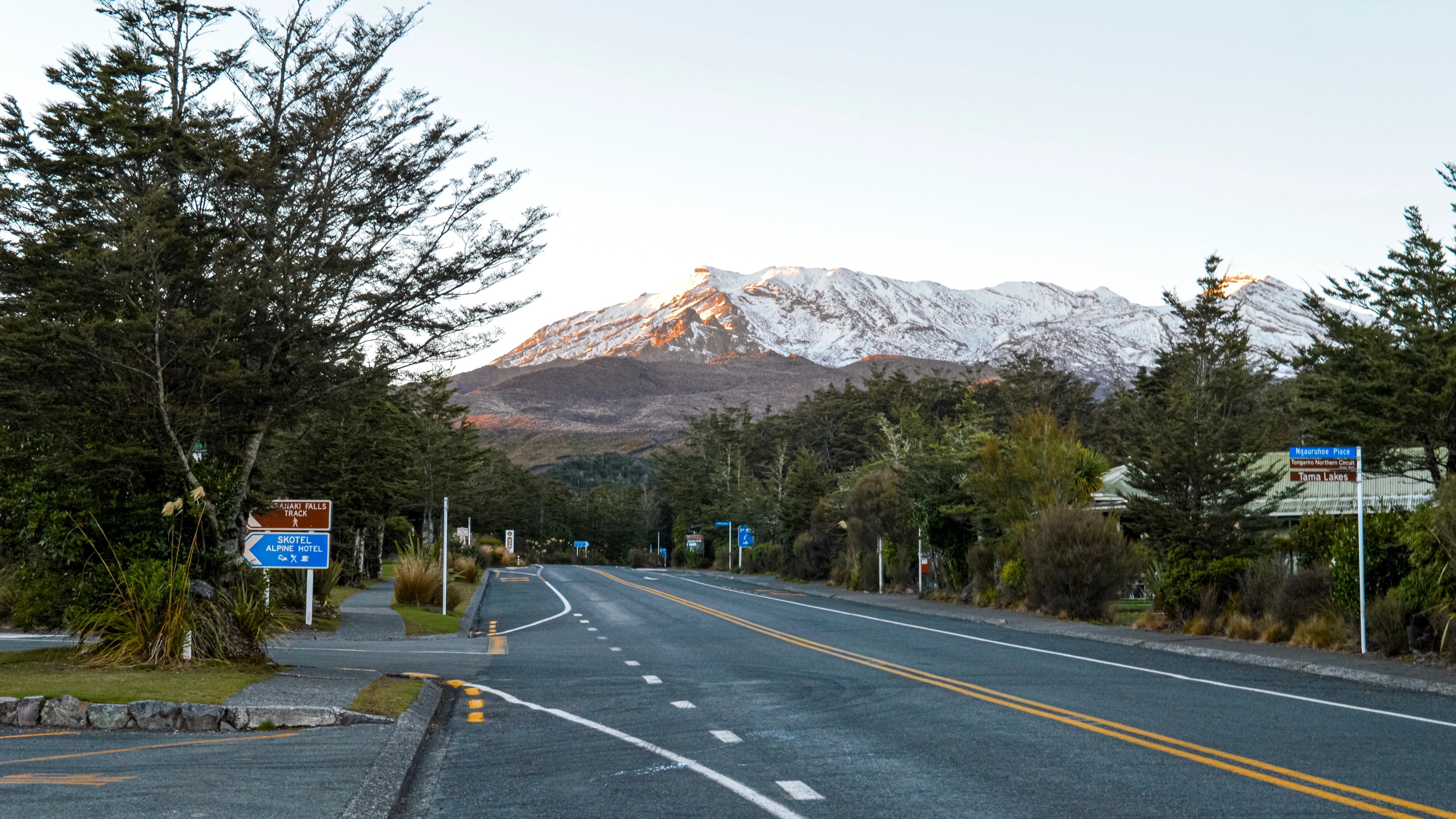 Early morning sun hitting snow covered peaks of Mount Ruapehu observed from the alpine village below the mountain, New Zealand.